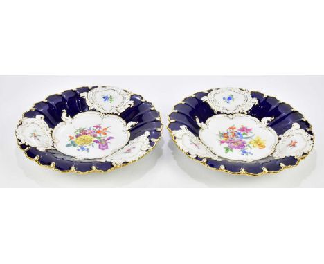 MEISSEN; a pair of 20th century hand painted gilt decorated pedestal bowls, each with floral sprays inside shaped cartouches,