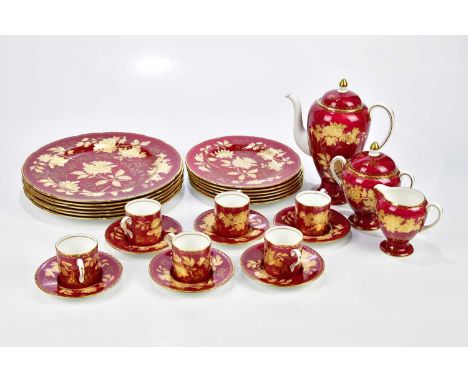 WEDGWOOD; a gilt decorated part tea and dinner service with floral sprays on a burgundy ground.Condition Report: Light wear/s