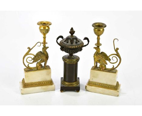 A pair of early 20th century gilt bronze and alabaster candle holders, the single sconces raised on mythical griffins, height