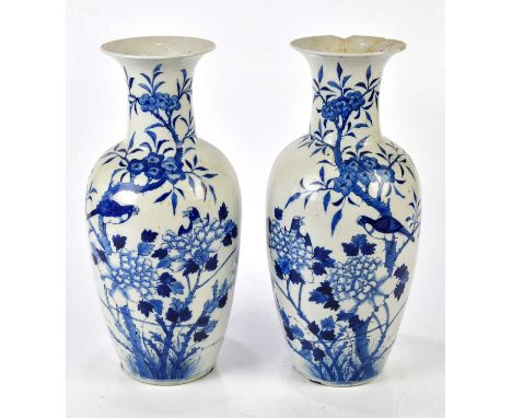 A pair of Chinese 19th century blue and white vases of shouldered form with flared necks and decorated with birds, prunus and