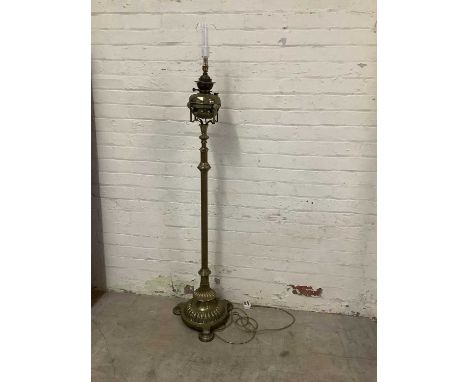 A Victorian brass adjustable standard oil lamp (converted to electricity) on circular plinth base gadrooned decoration, heigh