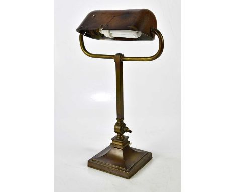 A late 19th century bronze desk lamp with rotating bakelite shade, height 45cm.