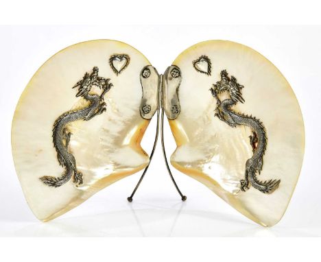 A Chinese silver mounted mother of pearl open shell, decorated to each panel with a three clawed dragon and stylised heart sh
