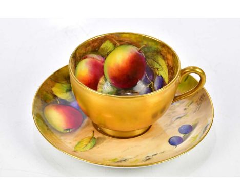 W. H. AUSTIN FOR ROYAL WORCESTER; a hand painted teacup and saucer, decorated with fruit, signed.Condition Report: A small re