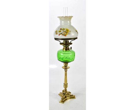 A green glass vessel oil lamp on brass shaped column, with floral decorated shade, height 66cm.