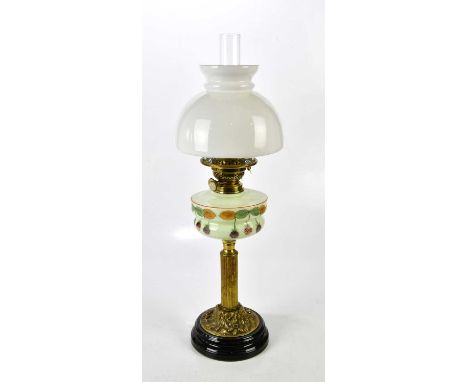 An original Victorian brass column oil lamp with acorn and oak leaf design brass base, on a glazed black ceramic plinth, the 