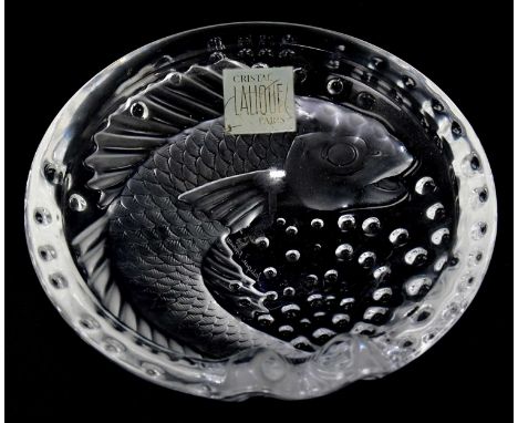 LALIQUE FRANCE; a clear and frosted glass ashtray, decorated with a fish, diameter 15.5cm, with original label.Condition Repo