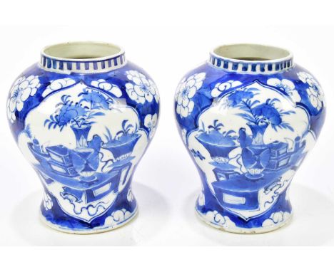 A pair of late 19th century Chinese blue and white porcelain vases, each decorated with objects and prunus flowers, bearing f