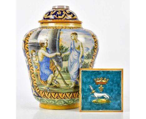 An 18th century Italian faience ware vase decorated with classical figures in panels beside mask heads and exotic birds, with