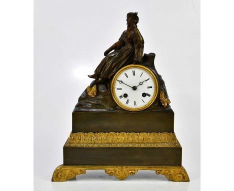 A Victorian bronze mounted mantel clock, the surmount decorated with a seated maiden above the drum shaped dial set with Roma