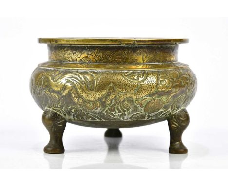 A 19th century Chinese bronze censer, with carved decoration depicting a dragon chasing the Pearl of Wisdom, with impressed s