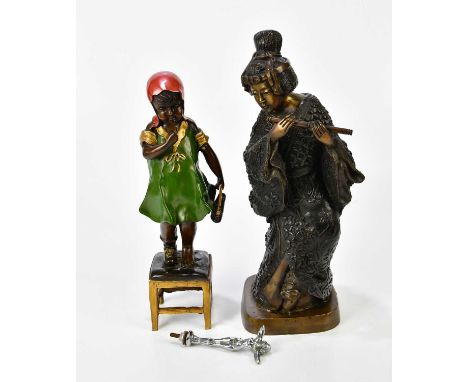 A reproduction bronze model of a Dutch girl standing on a stool holding her shoe, height 35cm, with a reproduction bronze mod
