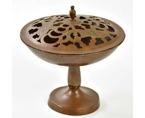 An Arts &amp; Crafts copper potpourri and cover with pierced decoration to the cover representing three fish, height 24cm.Pro