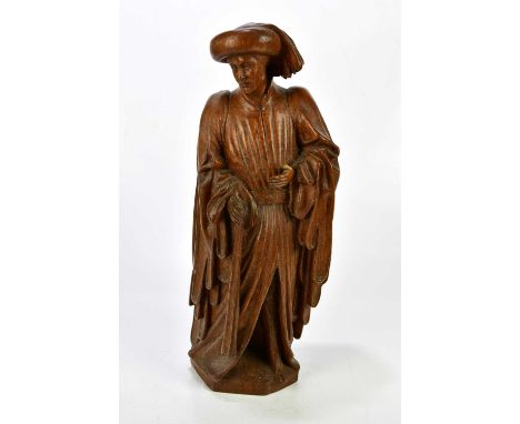 A large carved wooden sculpture depicting a gentleman wearing an overcoat, height 56cm.