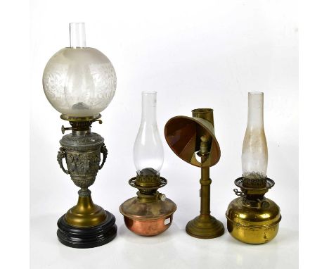 An early 20th century silvered metal oil lamp relief decorated with cherubs and classical scenes, with frosted glass shade, h