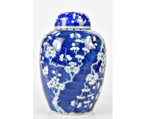 A 19th century Chinese blue and white porcelain ginger jar and cover, painted with prunus flowers, on a blue ground, bears fo