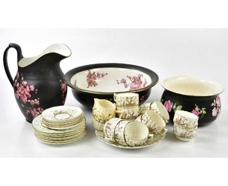 CARLTON WARE; a three-piece wash set with floral decoration on a black ground, and a late Victorian part tea service.