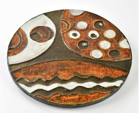 HELMUT SCHAFFENACKER; a German ceramic disc plaque, relief decorated with stylised motifs, impressed marks verso, diameter 39
