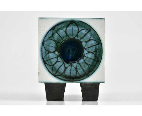 TROIKA; an early four footed cube, each side decorated with circular symbols and incised floral motifs, embossed Troika with 