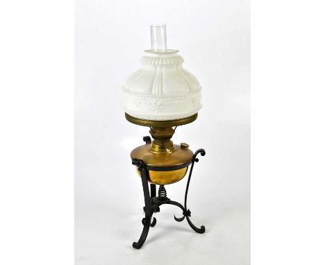 A late 19th/early 20th century oil lamp with domed milk glass shade and brass reservoir on black painted iron stand, height 5