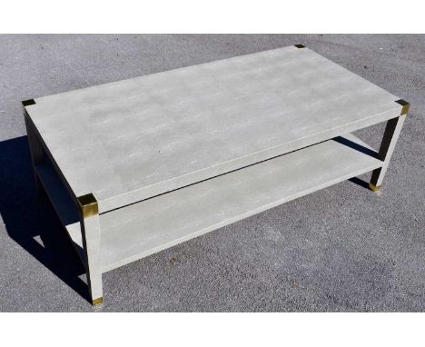 OKA; a Osiris faux shagreen coffee table with gilt metal mounts and undertier shelf, width 151cm, depth 75cm, height 48cm.