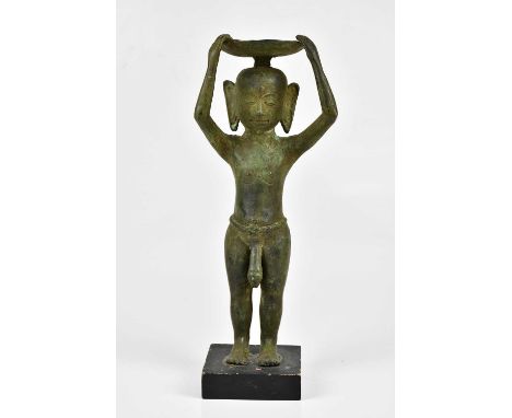 An East Asian bronze figure of a nude male, holding bowl upon his head, on wooden plinth base, height 34cm.