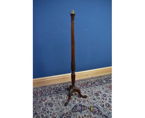 A carved mahogany standard lamp on ball and claw feet, height 153cm.