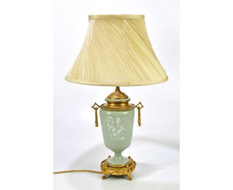 A late 19th century pâte-sur-pâte table lamp with ormolu mount and drop handles in the aesthetic movement style, the body dec