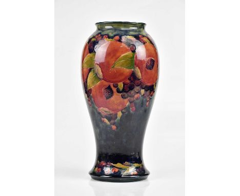 WILLIAM MOORCROFT; a large vase of inverted baluster form decorated in 'Pomegranate' pattern with four open pomegranate, bear