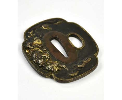 A Japanese bronze tsuba with gilt highlights, approx 7 x 6cm.