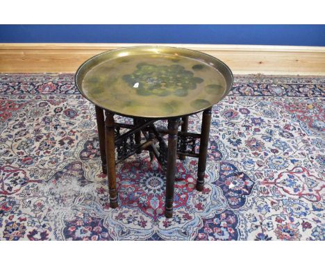 An Indian brass topped folding Benares table, together with a 1920s barley twist oak standard lamp, height excluding fitting 