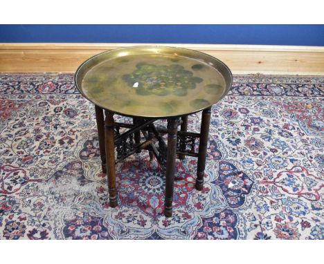 An Indian brass topped folding Benares table, together with a 1920s barley twist oak standard lamp, height excluding fitting 