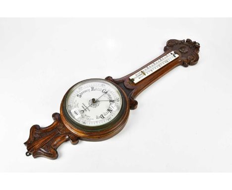 G &amp; R WINTER, PRESTON; an early 20th century carved walnut aneroid barometer, height 87cm.
