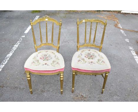 A pair of giltwood bedroom chairs with tapestry seats on turned column supports (2)