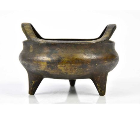 A Chinese bronze censer with pierced loop handles, tapering tripod supports, and spurious seal mark, width 12cm.