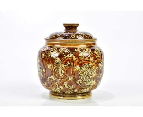ROBERT WALLIS MARTIN; a Martin Brothers tobacco jar and cover of squat bulbous form, with scrolling floral decoration, signed