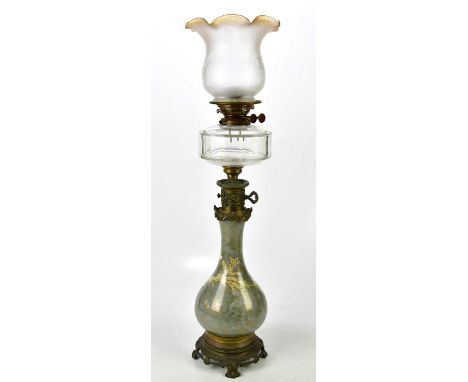 A Victorian style Continental oil lamp, with printed decoration of cherubs in landscape setting, with clear glass reservoir a