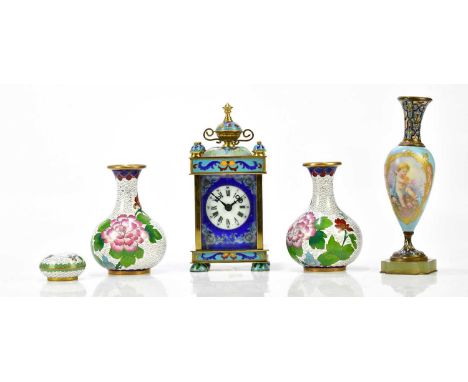 A decorative enamel carriage clock with twin handled urn finial, and a Champlevé enamel and porcelain urn vase decorated with