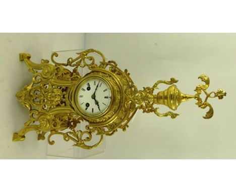 AN ORNATE FRENCH CAST BRASS CASED MANTEL CLOCK with mask decoration, white enamel dial with Roman numerals, 48cm high 