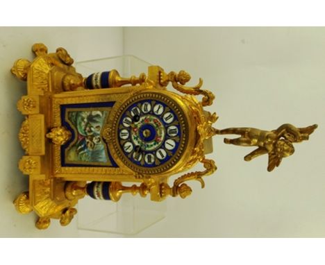 AN ORNATE FRENCH CAST GILT FRAMED MANTEL CLOCK inset with decorative ceramic panels, the dial with Roman numerals 
