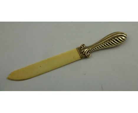 EDWARD HUTTON A SILVER HANDLED IVORY PAPER KNIFE, having pressed scrolled handle and plain blade, London 1910, 29cm long 