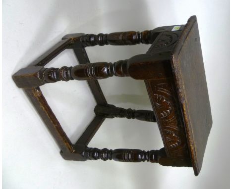 A 17TH CENTURY OAK JOINT STOOL, lunette chip carved frieze over ring turned supports with plain stretchers, 53cm high, top 45