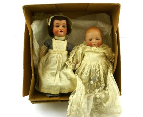 TWO SCHOENAU AND HOFFMEISTER EARLY 20TH CENTURY BISQUE HEAD DOLLS, one a baby in a christening robe, the other in a nursing u