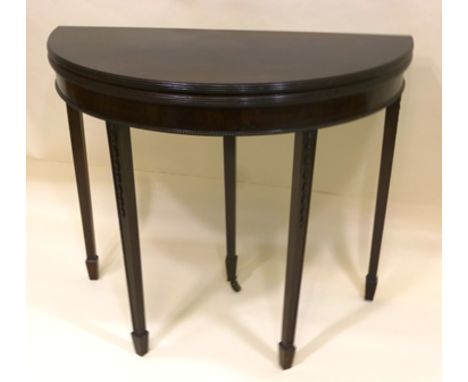 A GEORGIAN DESIGN MAHOGANY DEMI-LUNE FOLD OVER CARD TABLE raised on squared tapering spade feet supports, decorated with grad