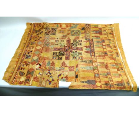 AN EARLY 19TH CENTURY UNFRAMED LARGE DECORATIVE SAMPLER a central panel surrounded by stylised flowers, in reds, blues, yello
