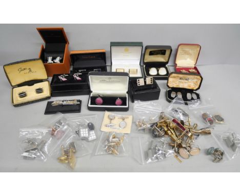 A collection of cufflinks and tie pins 