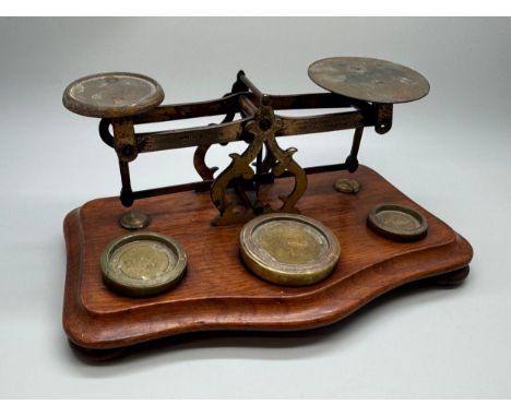 A set of Windle &amp; Blyth Victorian postal weighing scales on a mahogany base, with brass weights