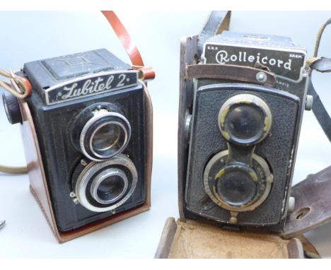 A Rolleicord camera and a Lubitel 2 camera, both in leather cases