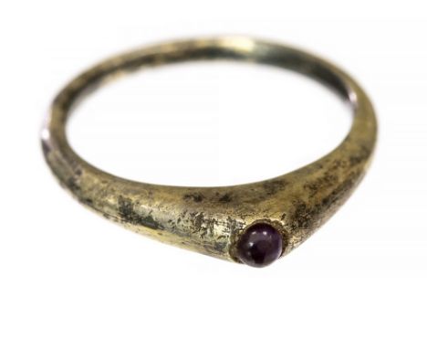 Medieval Silver-Gilt Stirrup Ring, 13th Century. Silver-gilt Medieval stirrup ring with a cabochon pink glass setting, most o