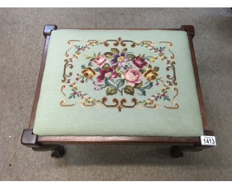 An Edwardian stool decorated with flower embroidery.